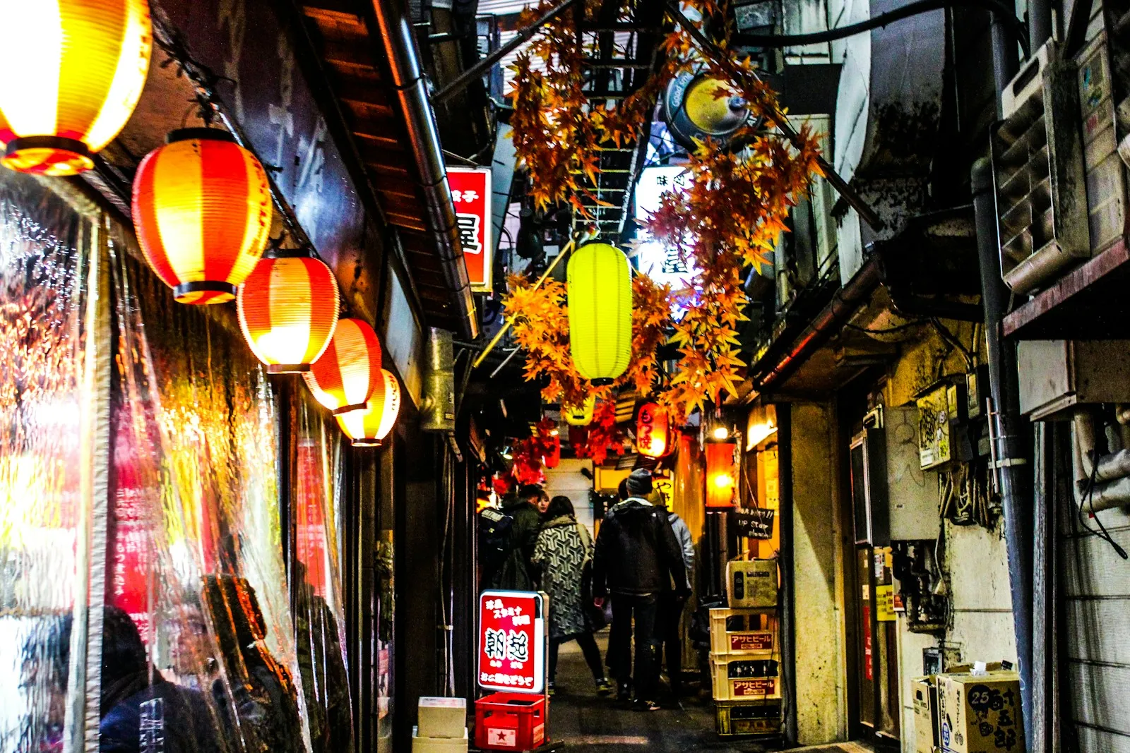 Small shops and stalls lining a narrow street in Shinjuku, Tokyo.